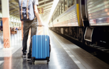 Visual of a person on the platform with his suitcase